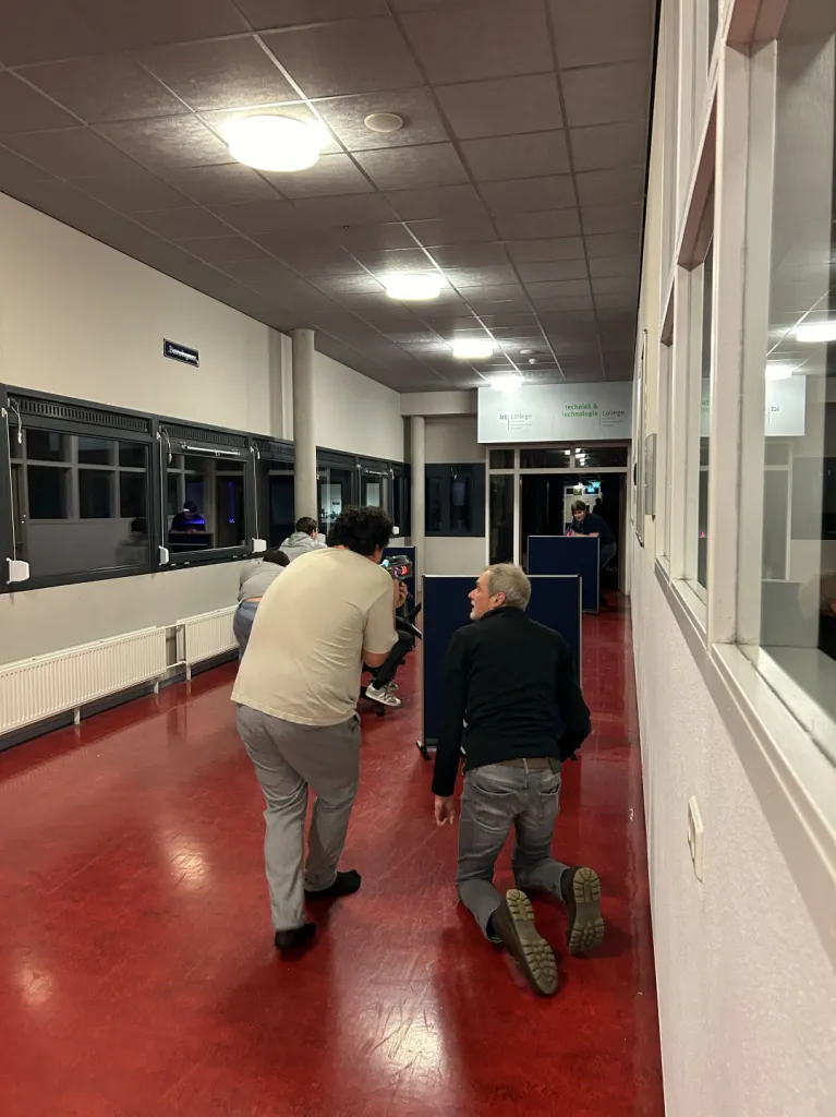 Students filming in an ICT college hallway
