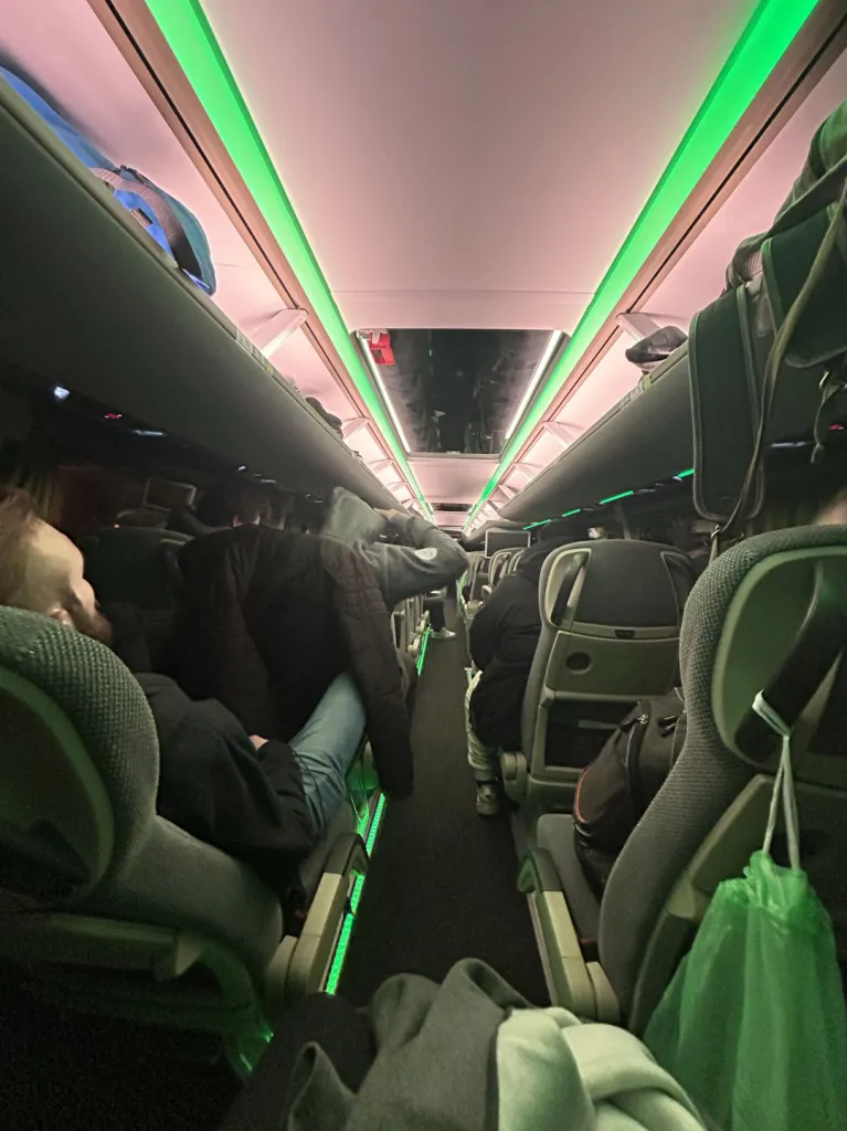Night bus interior with green LED aisle lighting