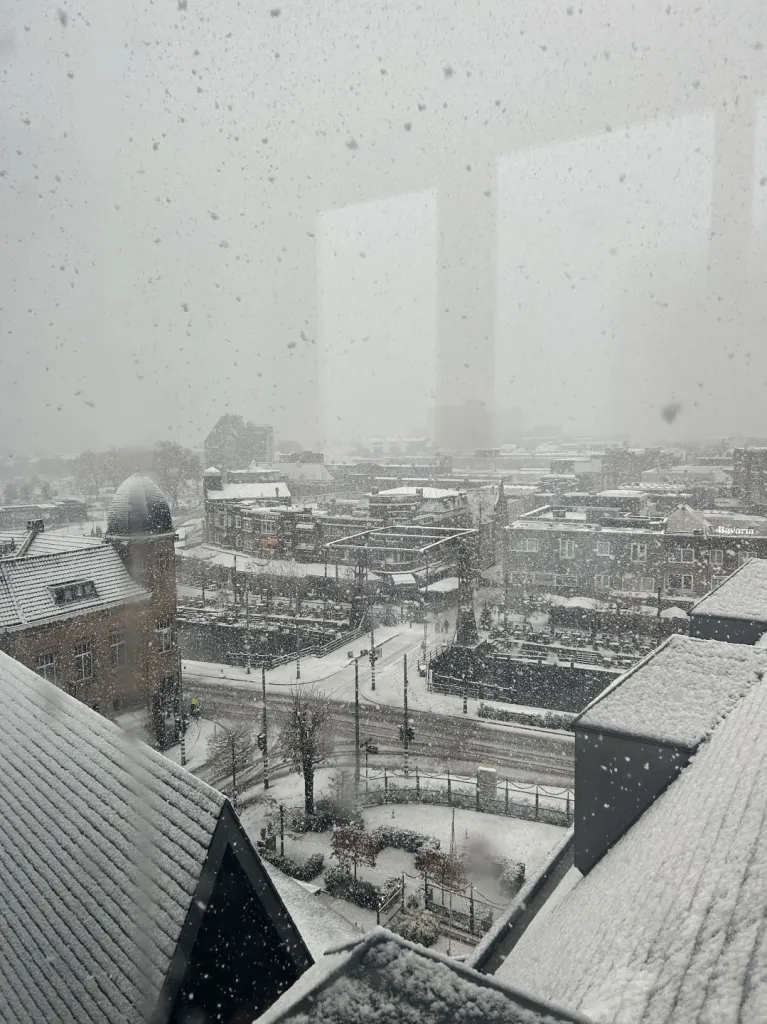 Snowstorm over the town square seen from a window